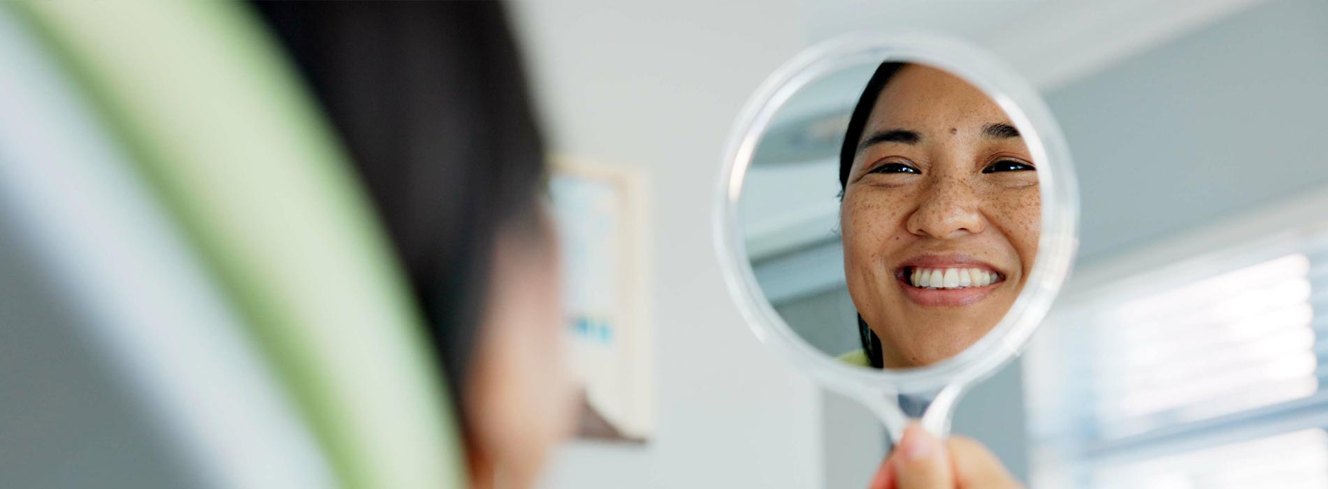 The image shows a modern dental clinic interior with various pieces of equipment, including a dental chair and an X-ray machine.
